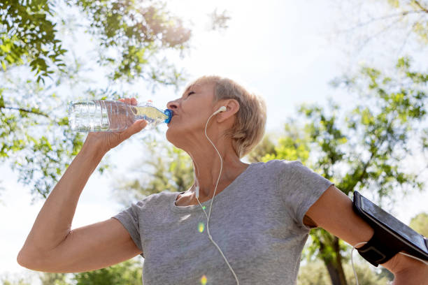 istock Mature woman getting refreshed after run 958569490