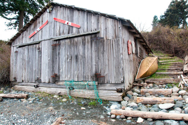 istock Weathered and worn boards on beach boat house 958569798