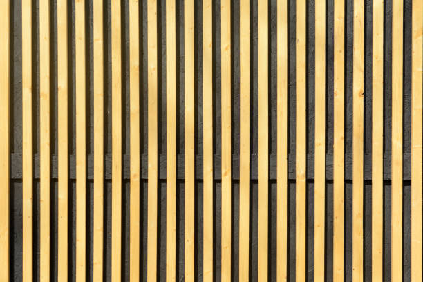 istock Wall of thin wooden slats. Vertical parallel plates. 958573090
