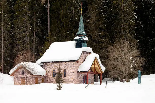 Photo of Church and snow covered trees behind