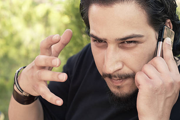 istock angry young man argue at mobile phone 95857793