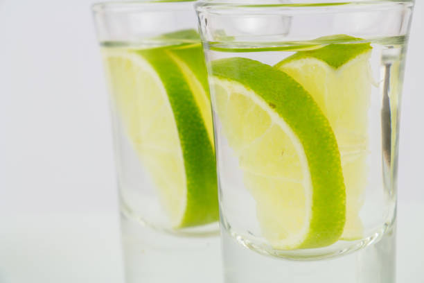 istock Two shots of vodka or tequila with lime 958580542