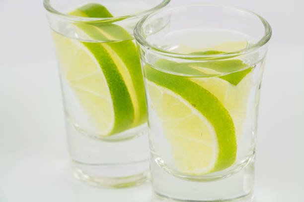 istock Two shots of vodka or tequila with lime 958580604