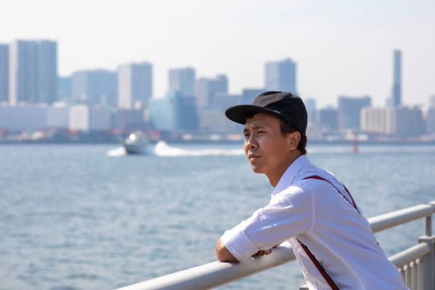 istock Young Asian guy at harbor in Tokyo 958588988