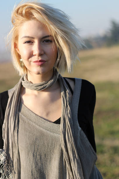 istock Attractive young blonde woman posing outside 958592872