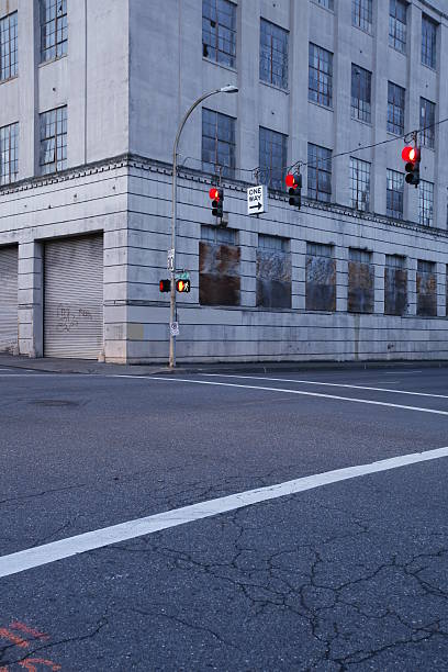 istock Corner warehouse building empty street red stoplight and no traffic 95859301