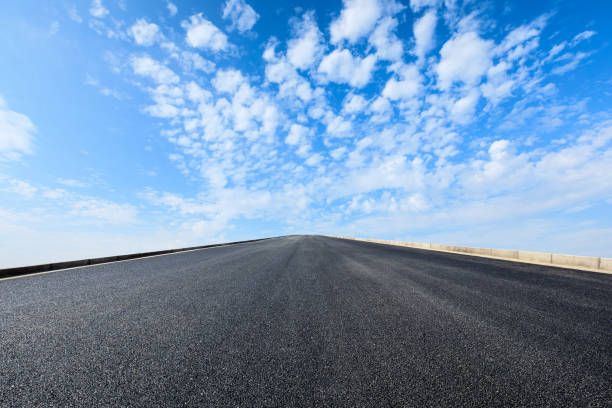 istock new asphalt road and sky clouds 958603766