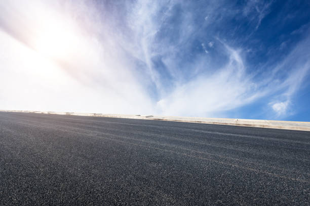 istock new asphalt road and sky clouds 958607782