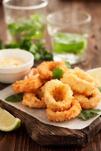 istock Fried calamari rings on wooden cutting board 958608026