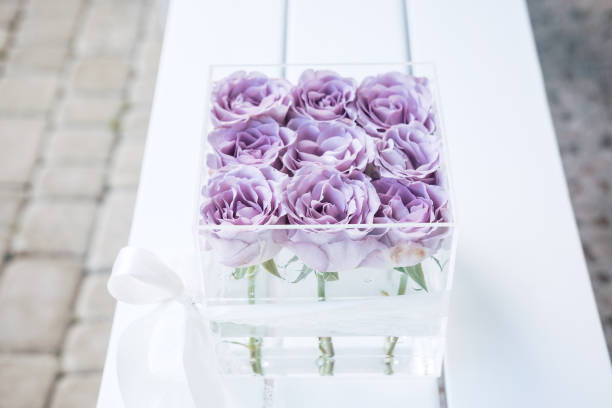 istock Pastel purple roses in clear acrylic box 958608290