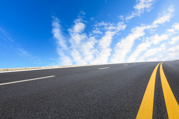 istock new asphalt road and sky clouds 958608304
