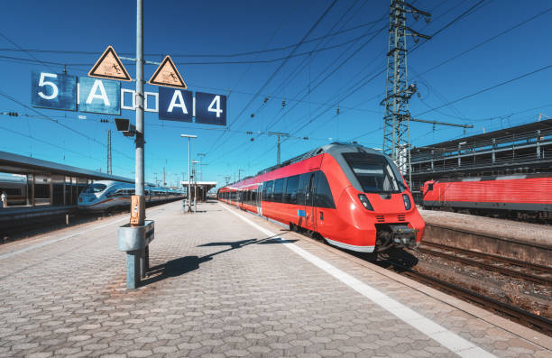 istock High speed red train on the railway station at sunset. Nuremberg, Germany. Modern intercity train on the railway platform. Industrial. Commuter train on railroad. Passenger transportation. Vintage 958608378