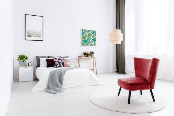 istock Red armchair in white bedroom 958608854