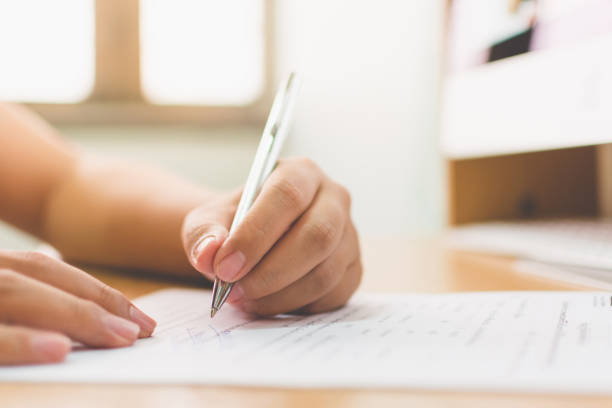 istock Businessman hand signing the document business contract agreement 958612018
