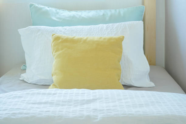 Yellow pillow lay on comfy bed in kid bedroom stock photo