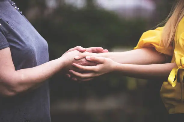 Old and Young helping hands connected