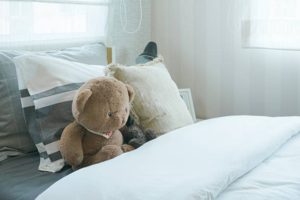 istock Brown teddy bear on bed in kid bedroom 958618290