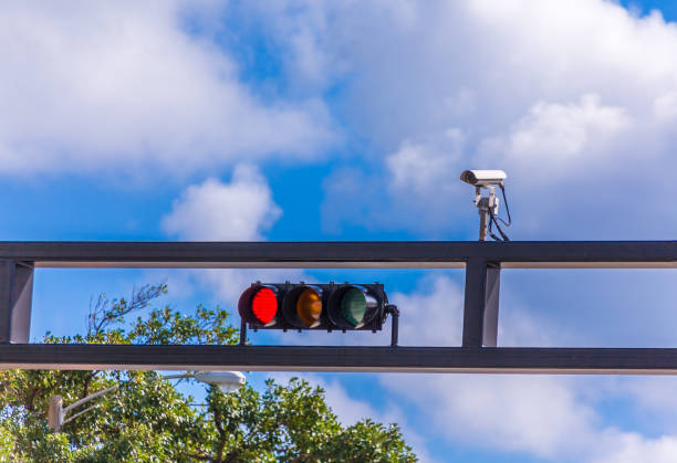 Red Light Camera A traffic camera over a traffic light showing red red light stock pictures, royalty-free photos & images