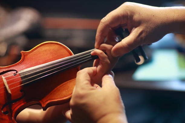 istock A person playing the violin showing hands holding the bow 958629740