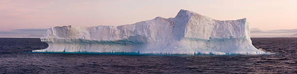 Large Iceberg Floating in Sea stock photo