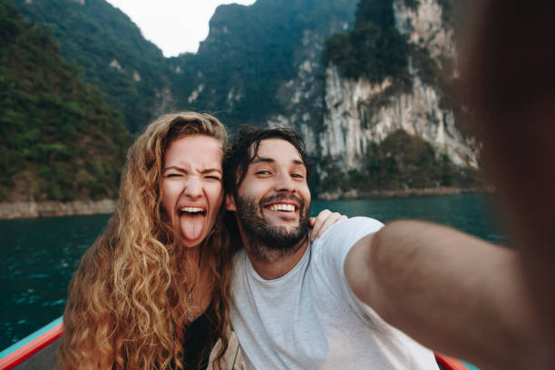 Couple taking selfie on a longtail boat