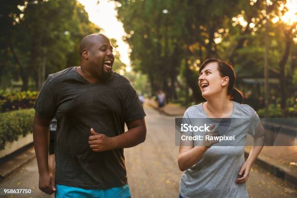 Couple Having Fun Together At The Park Stock Photo - Download Image Now - Dieting, Exercising, Men