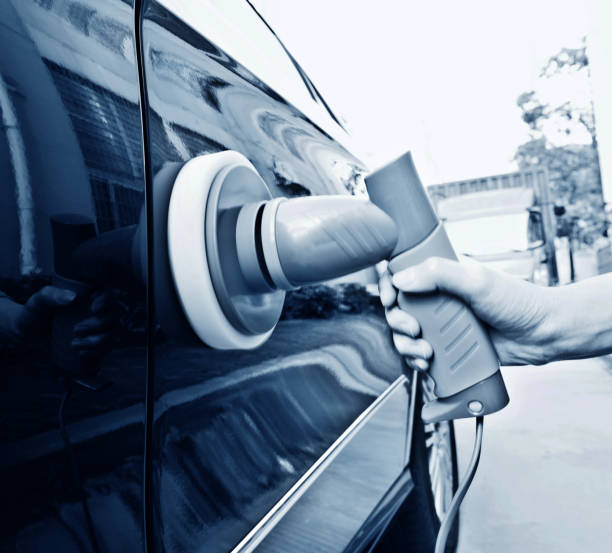 istock Woman hand using hand held car polishing machine 958637774
