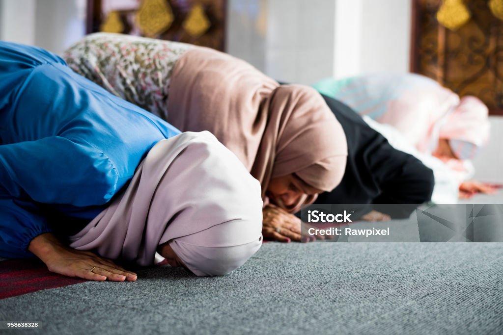 Muslim women praying in the mosque during Ramadan Islam Stock Photo
