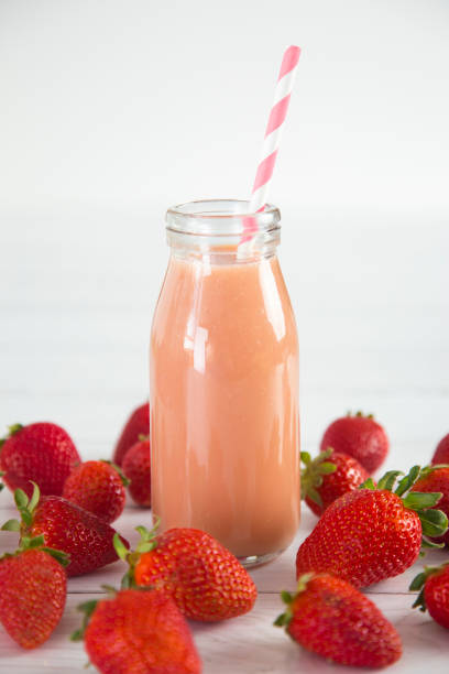 istock Strawberry Fruit Smoothy on a White Wood Table 958638652