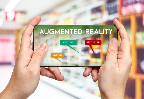 Hand hold mobile phone and using augmented reality ( AR ) app for see promotion sale in supermarket store,Digital lifestyle Technology concept