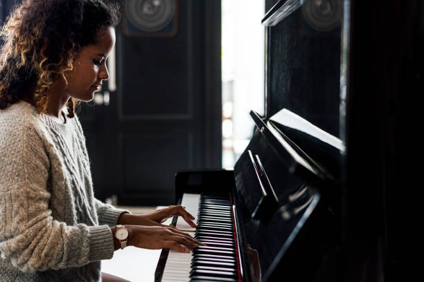 istock Woman playing on a piano 958639250
