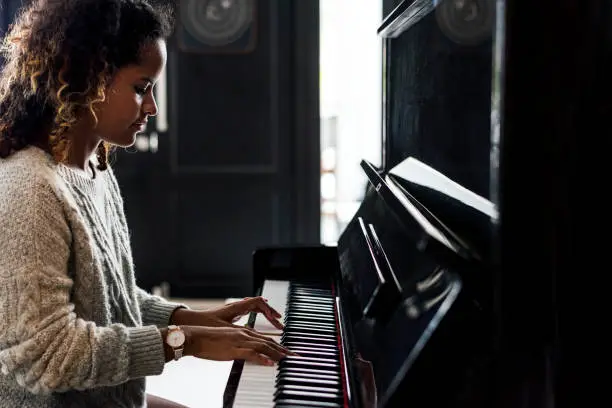 Photo of Woman playing on a piano