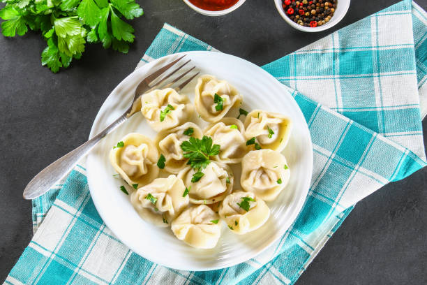 istock Homemade ready dumplings on a gray concrete table. 958643112