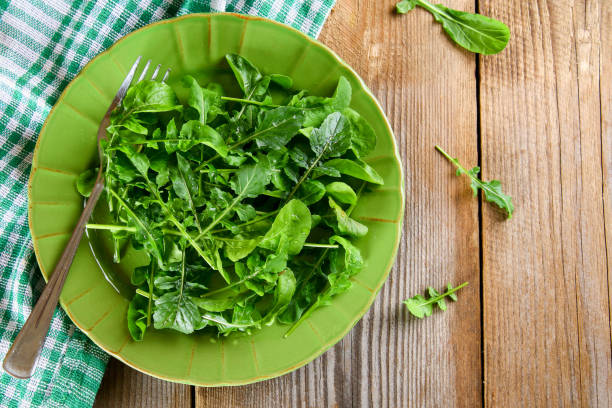 istock Fresh green home arugula leaves, rucola. Salad. 958643170