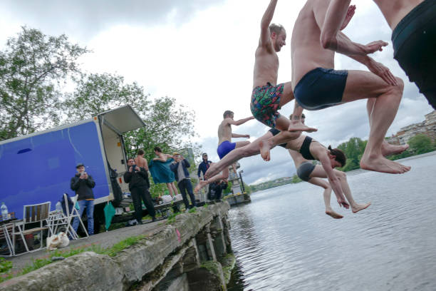 Stockholm, Sweden Stockholm, Sweden May 13, 2018 Young people jump into the lake after a hot sauna. swedish sauna stock pictures, royalty-free photos & images