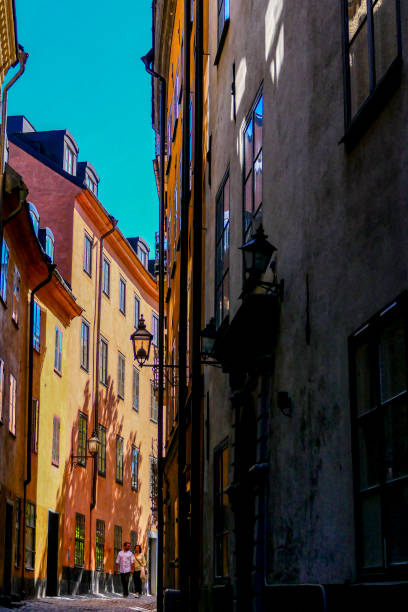 Stockholm, Sweden May 13, 2018 Couple walking along Baggensgatan in Gamla Stan or Old Town, the medieval center of the city. Back streets.