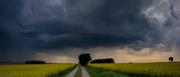 istock approaching storm over a country road 958647170