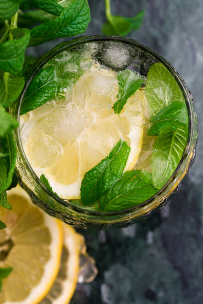 istock Tasty cold fresh drink lemonade with lemon, mint and ice 958647414