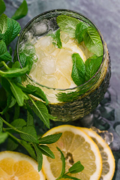 istock Tasty cold fresh drink lemonade with lemon, mint and ice 958647932