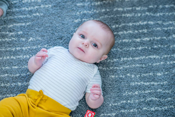 istock Baby Laying On Carpet 958653126