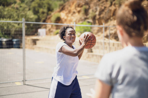 istock Female basketball player about to throw ball 958654154