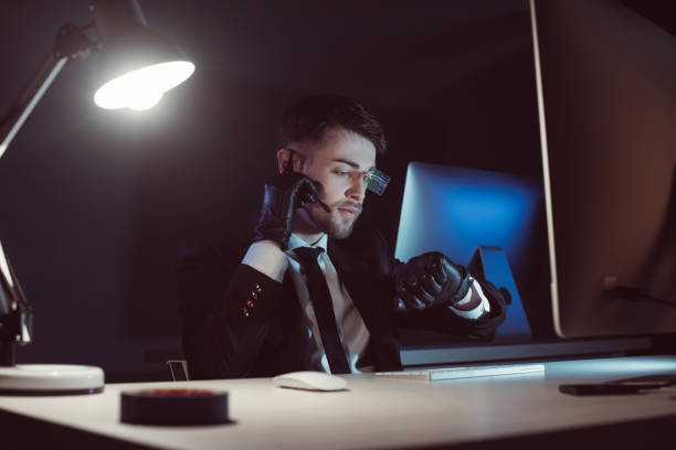istock portrait of spy agent in gloves with headset checking time at table with computer screen in dark 958656738