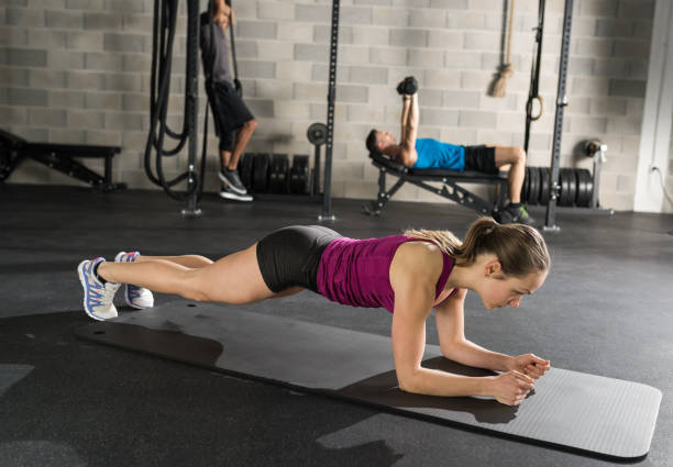 istock Muscular Woman On A Plank Position 958657038