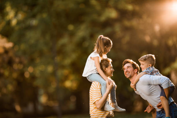 istock Carefree parents having fun with their kids in spring day. 958657478