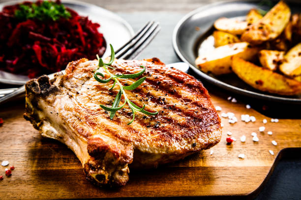 istock Grilled pork chop and vegetables 958657900