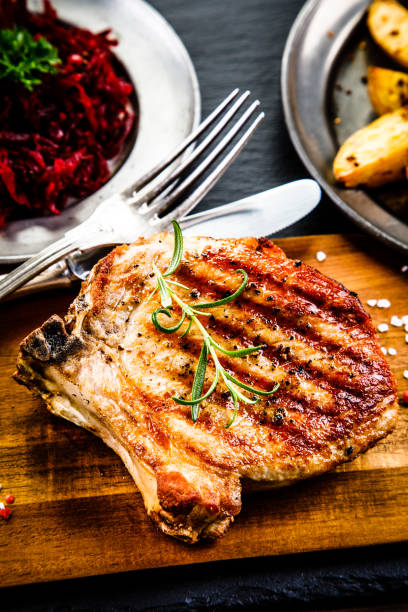 istock Grilled pork chop and vegetables 958657916
