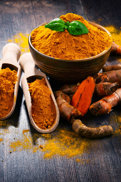 istock Composition with bowl of turmeric powder on wooden table 958658826