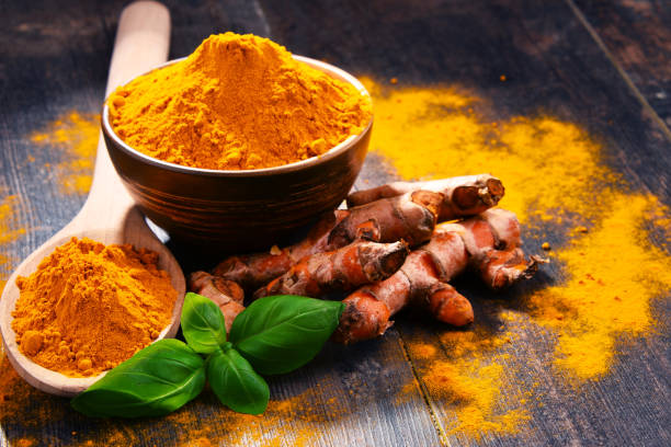 istock Composition with bowl of turmeric powder on wooden table 958659026