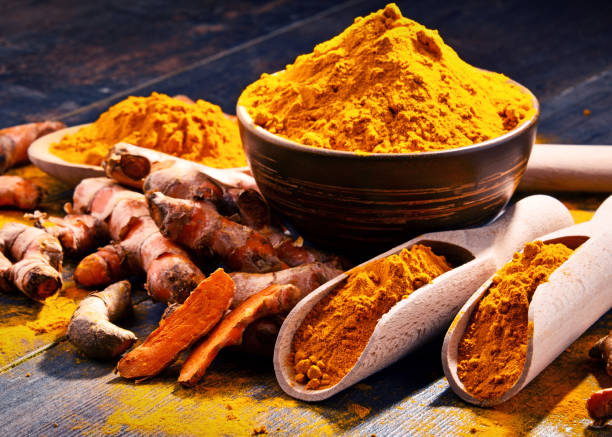 istock Composition with bowl of turmeric powder on wooden table 958659252