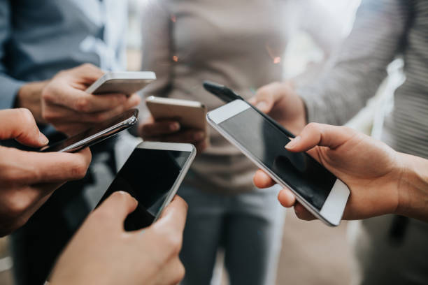 istock Close up of unrecognizable business people using mobile phones. 958659520